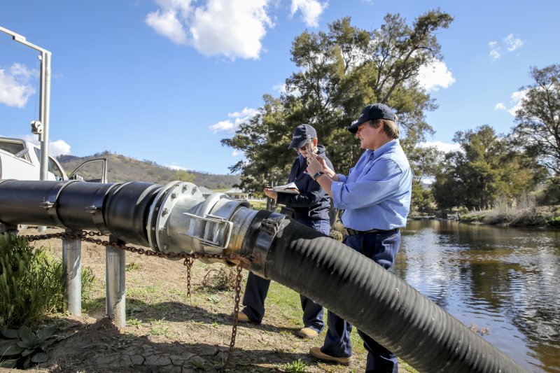 NRAR officer taking photo of water pump during an inspection